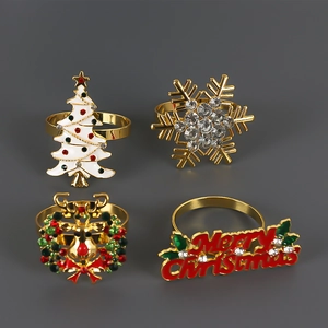 Christmas napkin ring set with gold metal reindeer, snowflake and tree motifs