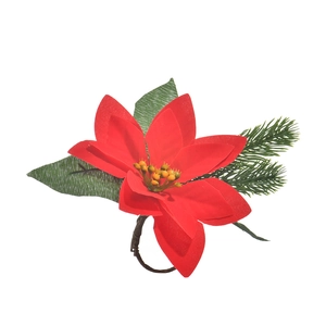Detail of handmade Christmas napkin ring with red poinsettia flowers and green pine needles