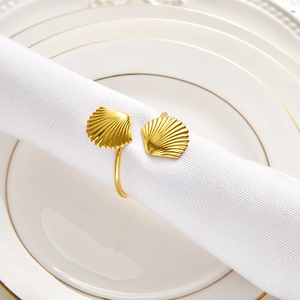 Elegant gold seashell napkin ring set featuring symmetrical ocean-style shell accents