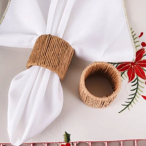 Macro shot of handmade woven napkin ring with natural grass texture on a festive tablecloth