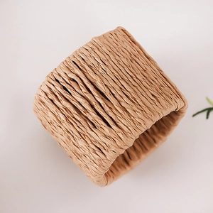 Macro shot of hand-woven straw napkin ring showing natural texture and craftsmanship