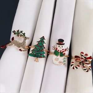 Set of four Christmas napkin rings with reindeer, tree, snowman and cane designs