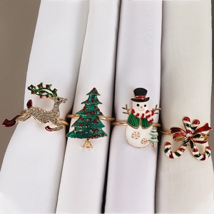 Christmas napkin ring set featuring reindeer, tree, and snowman with sparkling rhinestones