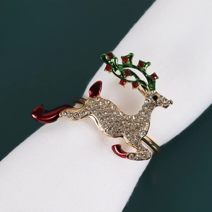 Detail of a golden elk napkin ring with sparkling crystals and colorful enamel finish