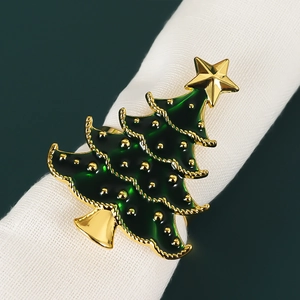 Macro detail of dark green Christmas tree napkin ring with gold edges and star