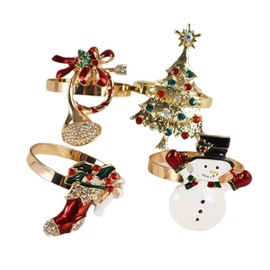 Set of Christmas napkin rings featuring crystal Christmas tree, snowman, and stocking icons