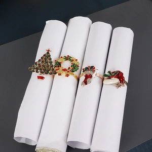 Detailed view of Christmas napkin rings set featuring enameled tree, wreath, sock, and hat