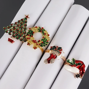 Detail of Christmas napkin rings featuring enameled tree, wreath, sock and hat designs