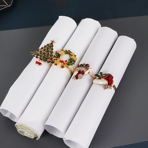 Detailed close-up of festive napkin rings with rhinestone Christmas tree and wreath designs