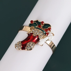 Macro shot of gold metal Christmas stocking napkin ring with rhinestones and enamel detail
