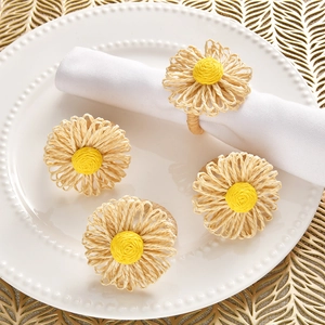 Detail of handmade woven daisy napkin rings with yellow centers and straw petals