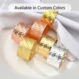 Detail showing woven mesh texture of rose gold and silver metal napkin rings on table