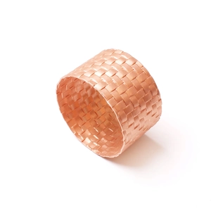 Modern rose gold metal woven napkin ring with a polished textured finish for table setting