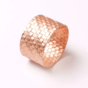 Elegant rose gold woven napkin ring with a polished metallic finish for table decor