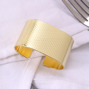Matte gold C-shaped napkin ring with hammered texture for elegant table settings