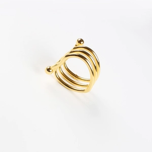 Detailed macro view of triple-layered golden spring napkin ring with polished metal beads
