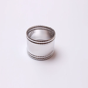 Close-up of polished silver napkin ring featuring elegant double beaded textured edges