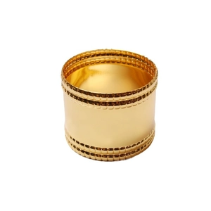 Polished gold napkin ring with double row checkered embossing on white background
