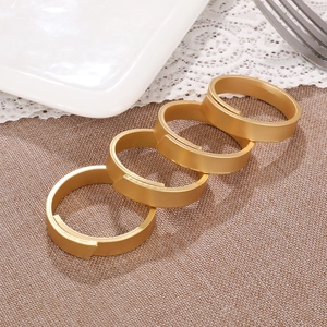 Set of 4 matte gold metal napkin rings with a minimalist wide circular design