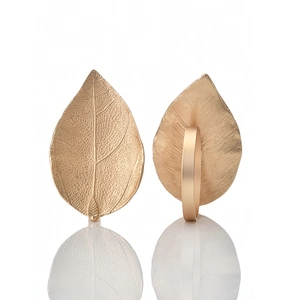 Golden leaf napkin ring with detailed vein texture for elegant table decoration