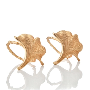 Detail of golden ginkgo leaf napkin ring with matte metallic texture and fine veins