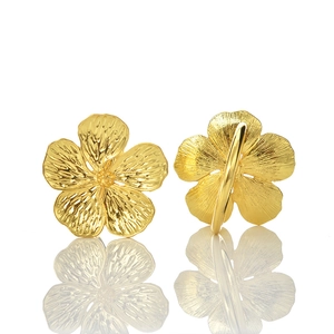 Golden flower stud earrings with textured petals and metallic floral design on white background