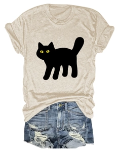 Detailed flat lay of beige t-shirt with black cat print and frayed denim shorts