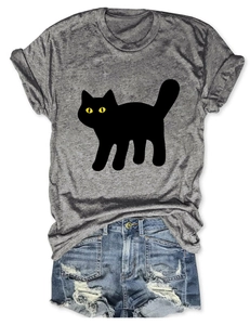 Flat lay of gray marl cat print t-shirt paired with distressed blue denim shorts