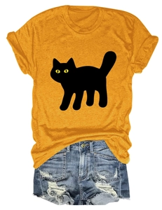 Flat lay of a yellow cat graphic t-shirt paired with frayed denim shorts