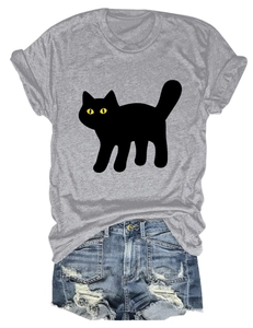 Flat lay of casual grey T-shirt with black cat print and ripped denim shorts for summer