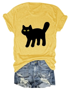 Flat lay of yellow cotton t-shirt with black cat print and distressed denim shorts
