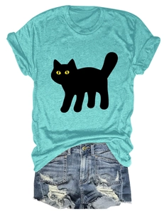 Detailed close-up of a blue T-shirt with a black cat print and ripped denim shorts