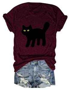 Close-up of a burgundy t-shirt with a black cat print and ripped denim shorts for women