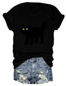 Detailed flat lay of a black cat print T-shirt and distressed denim shorts