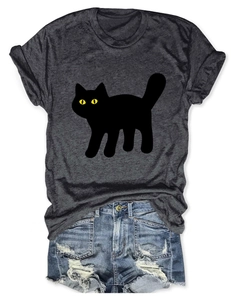 Flat lay of a grey cat print T-shirt paired with distressed denim shorts on white background