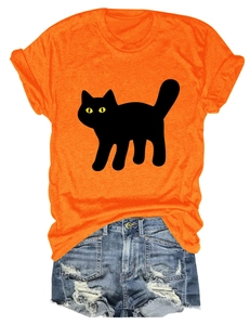 Flat lay detail of casual orange cat print T-shirt with distressed blue denim shorts