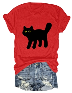 Flat lay of red cotton t-shirt with black cat graphic and distressed denim shorts
