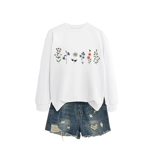 Women white crewneck sweatshirt with colorful floral print and denim shorts outfit set