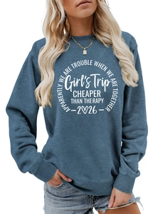 Close-up of white Girl's Trip circular print on blue cotton crewneck sweatshirt