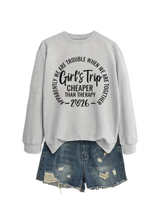 Close-up of Girl's Trip lettering print on grey sweatshirt with denim shorts set