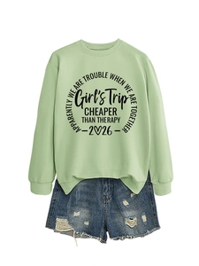 Flat lay of a mint green sweatshirt with Girl's Trip print and distressed denim shorts
