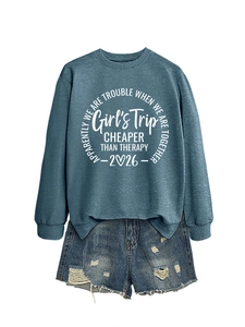 Flat lay of a grey sweatshirt with Girl's Trip print paired with distressed denim shorts