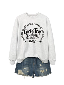 Flat lay of gray sweatshirt with Girl's Trip lettering and distressed denim shorts detail