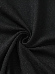 Detailed macro view of soft breathable black cotton knit fabric texture and texture ripples