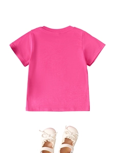 Flat lay of pink cotton kid's T-shirt paired with beige lace bow leather shoes