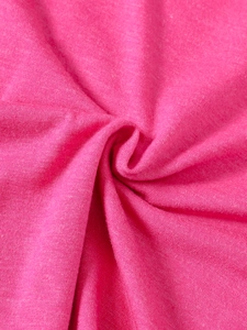Detailed macro view of soft rose red knitted fabric texture with flexible ribbed material