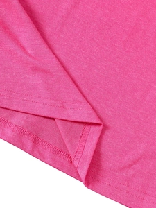 Close-up of rose pink knit fabric hem showing double-needle stitching and fine texture