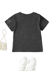 Flat lay of a grey short-sleeve kids T-shirt with a white pearl bag and stylish shoes