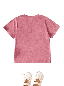 Flat lay of pink heathered girl's short sleeve T-shirt with white bow princess shoes
