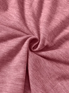 Close-up of soft dusty pink knit fabric texture for breathable kids' casual shirts